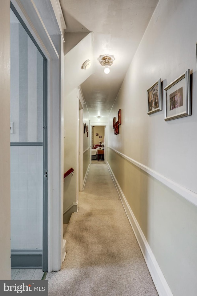 hallway featuring light colored carpet