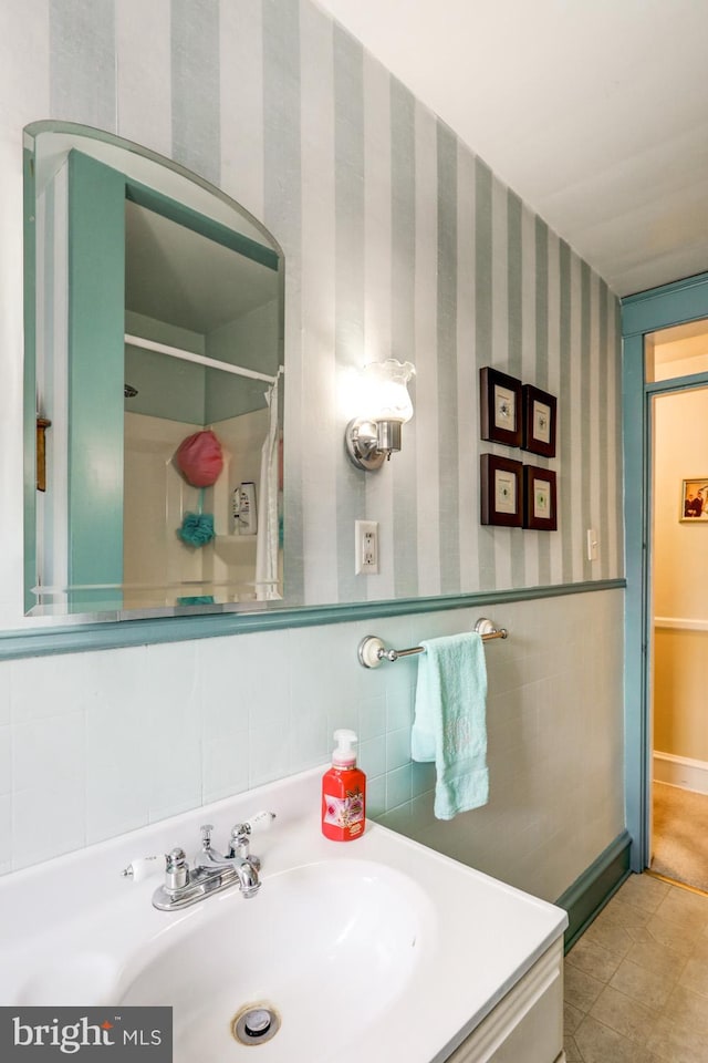 bathroom featuring tile walls, tile patterned flooring, and vanity