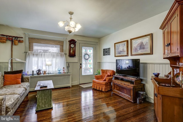 living room with an inviting chandelier and dark hardwood / wood-style floors