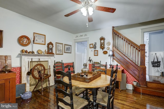 dining space featuring ceiling fan and dark hardwood / wood-style flooring