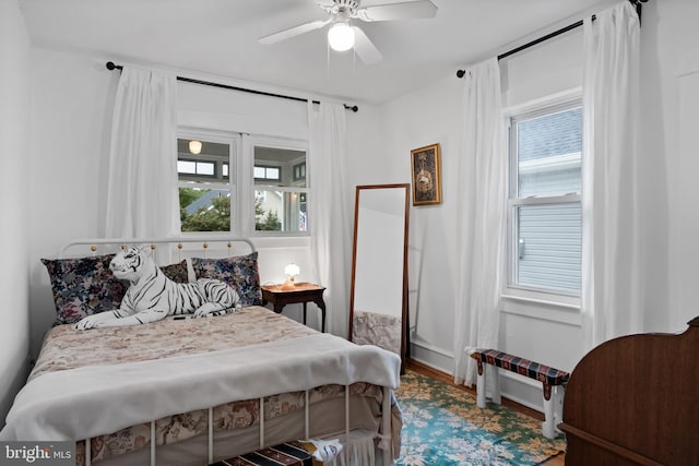 bedroom with hardwood / wood-style floors and ceiling fan