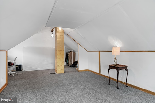 bonus room with vaulted ceiling and carpet