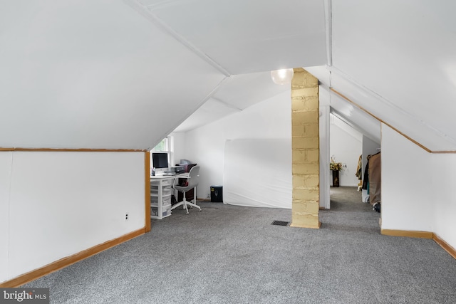 bonus room with lofted ceiling and carpet floors