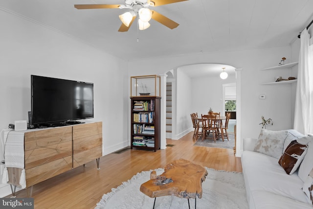 living room with light wood-type flooring and ceiling fan