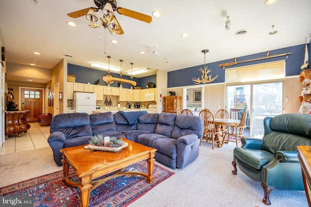 living room featuring light carpet, ceiling fan, and plenty of natural light