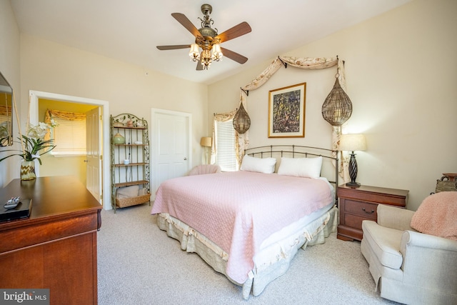 carpeted bedroom featuring ceiling fan and multiple windows