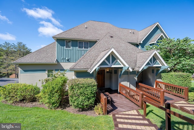 view of front of property featuring a front lawn and a wooden deck