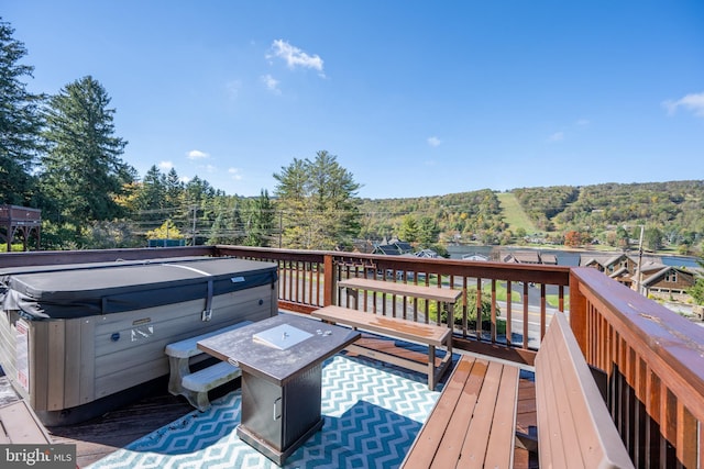 wooden deck with a hot tub