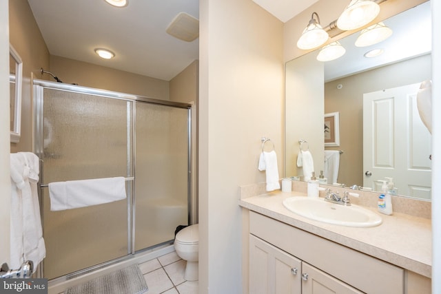 bathroom featuring walk in shower, tile patterned flooring, vanity, and toilet