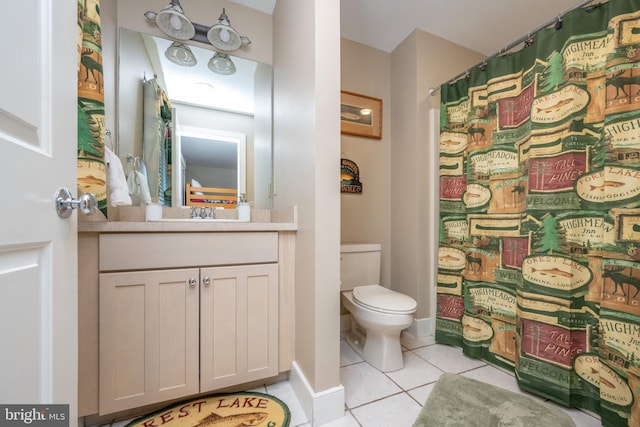 bathroom with tile patterned floors, vanity, and toilet