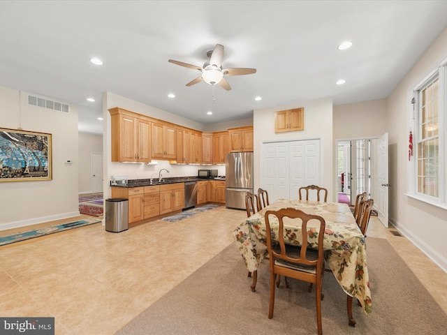 kitchen with ceiling fan, sink, light tile patterned floors, and stainless steel appliances