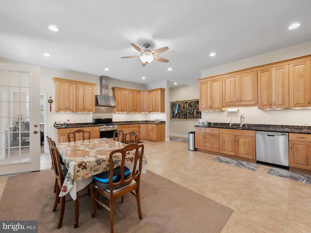 kitchen featuring ceiling fan, sink, stainless steel appliances, wall chimney range hood, and light brown cabinetry