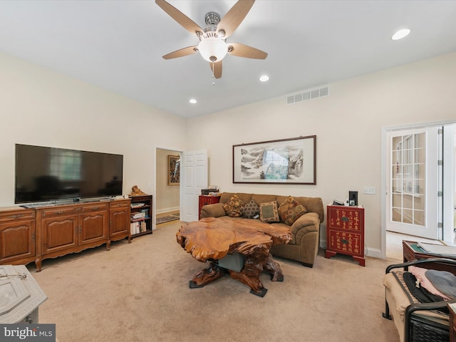 carpeted living room featuring ceiling fan