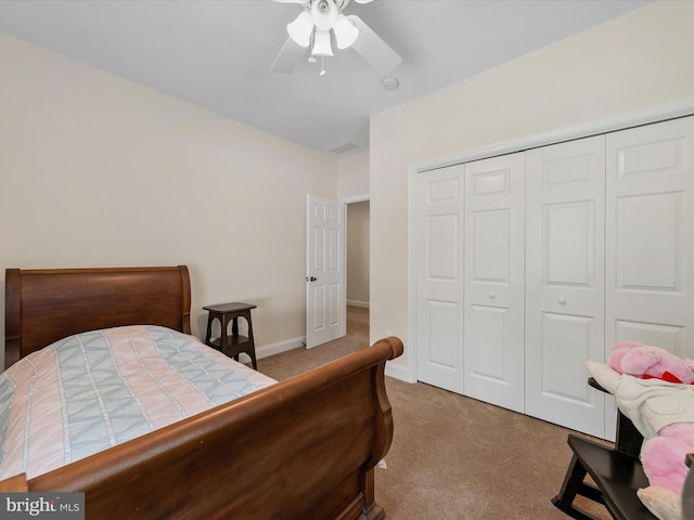 carpeted bedroom featuring a closet and ceiling fan