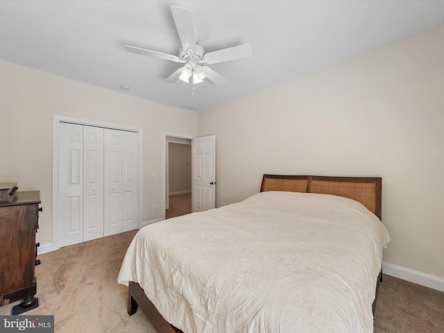 bedroom featuring ceiling fan, a closet, and light carpet