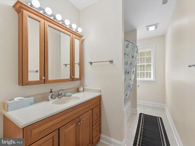 bathroom with tile patterned flooring, shower / bath combo, and vanity