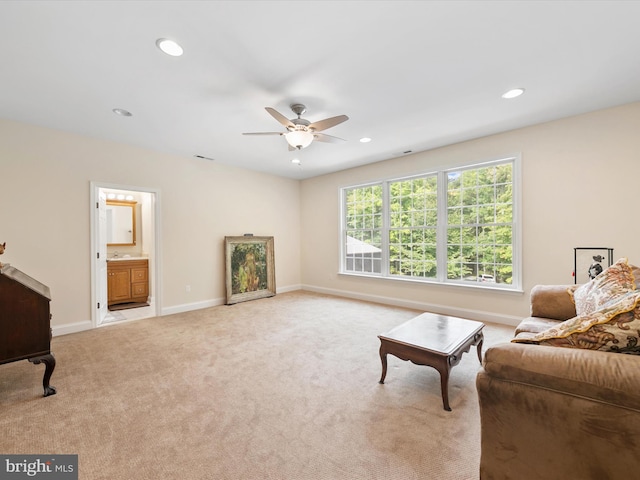 living room with ceiling fan and light colored carpet