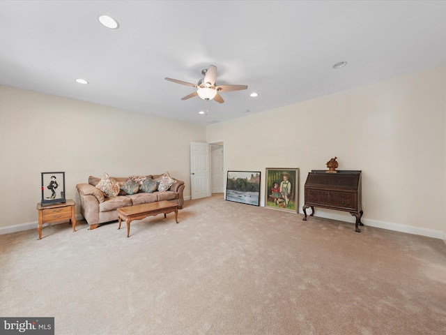 living area featuring ceiling fan and light colored carpet