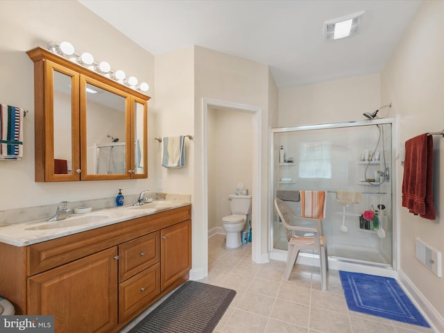 bathroom with toilet, vanity, tile patterned floors, and an enclosed shower