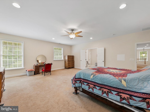 carpeted bedroom with multiple windows and ceiling fan