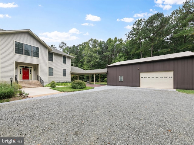 view of front of home featuring a garage and an outdoor structure