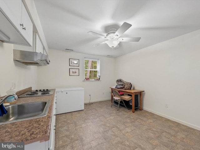 kitchen with white cabinets, sink, ceiling fan, fridge, and white cooktop