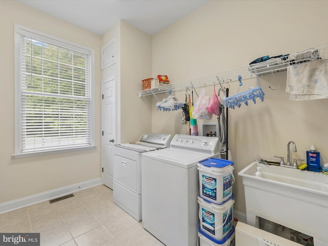 laundry room with independent washer and dryer and sink