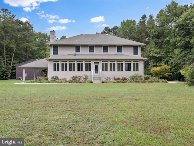 rear view of house with a yard and a carport