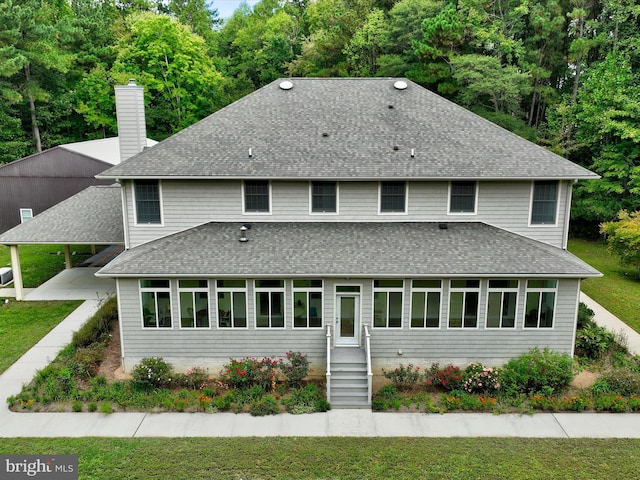 rear view of house featuring a carport