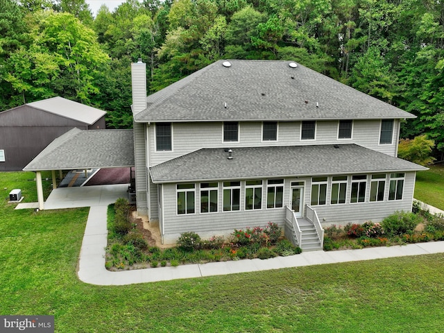 rear view of house featuring a patio and a lawn