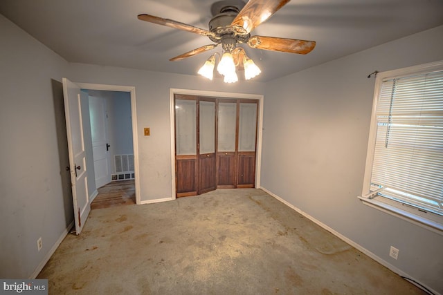 unfurnished bedroom with ceiling fan, light colored carpet, and a closet