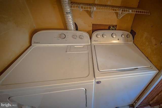 clothes washing area featuring independent washer and dryer