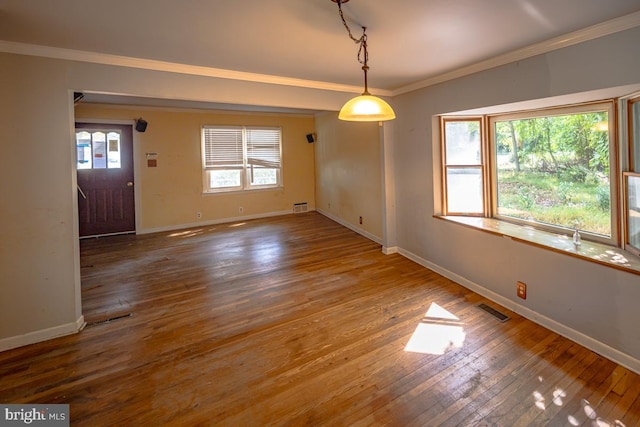 unfurnished room featuring wood-type flooring and crown molding