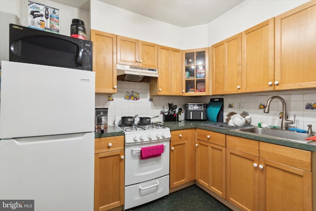 kitchen featuring backsplash, sink, and white appliances