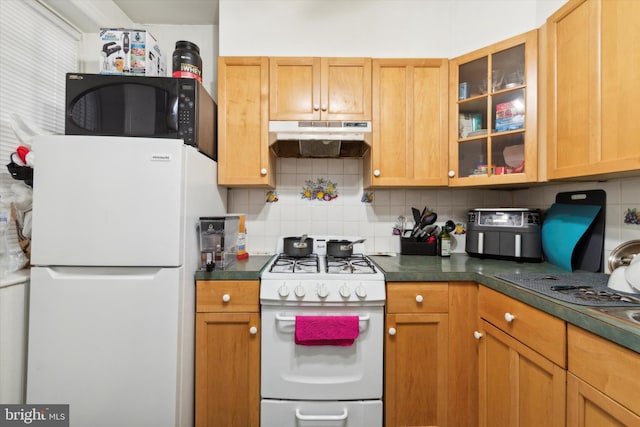 kitchen with white appliances and backsplash