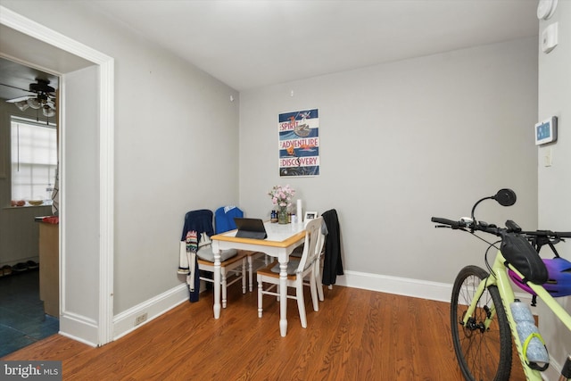 dining space featuring ceiling fan and hardwood / wood-style floors