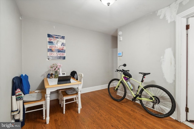 home office with hardwood / wood-style flooring