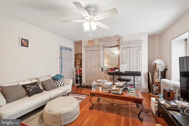 living room with ceiling fan and wood-type flooring