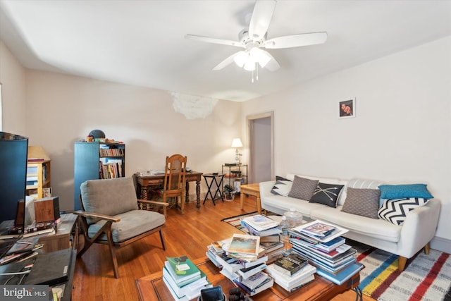 living room with ceiling fan and hardwood / wood-style floors