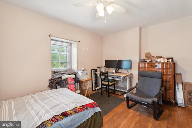 bedroom with wood-type flooring and ceiling fan