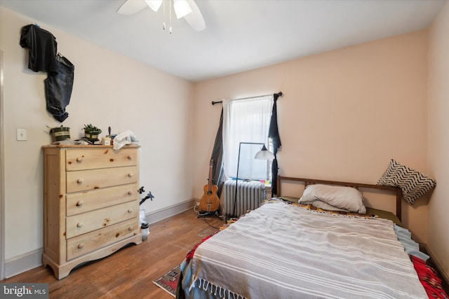 bedroom with ceiling fan and hardwood / wood-style floors