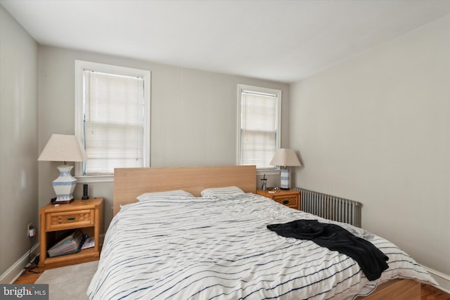 bedroom with light wood-type flooring and multiple windows