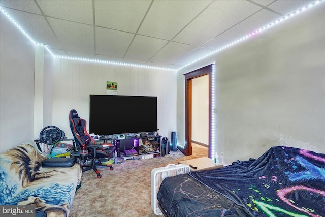 bedroom with carpet flooring and a paneled ceiling