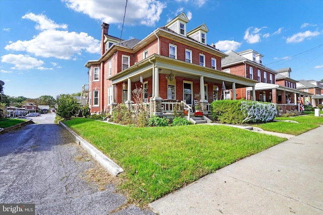 view of front of property with a porch and a front yard