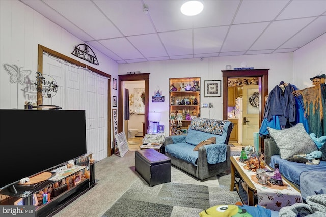 carpeted living room with a drop ceiling