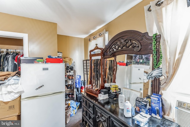 kitchen with white refrigerator and carpet flooring