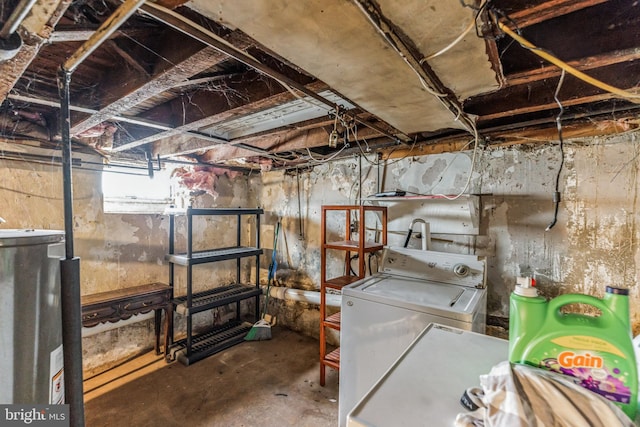 basement featuring water heater and washing machine and dryer