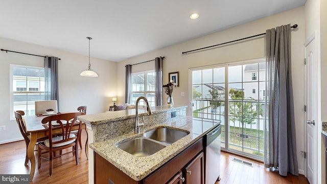 kitchen featuring pendant lighting, a healthy amount of sunlight, and sink