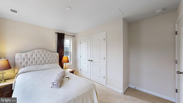 bedroom with light carpet and a closet