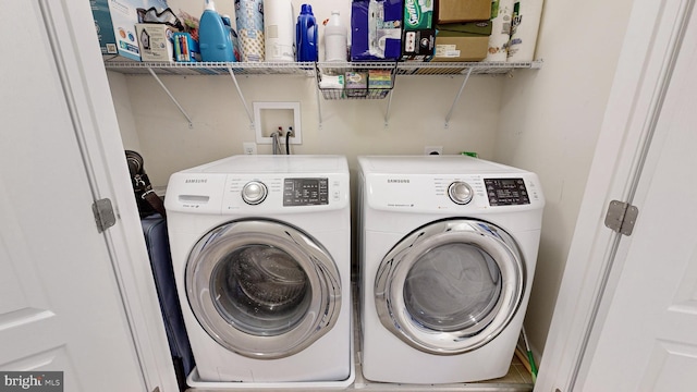 laundry area with washing machine and clothes dryer